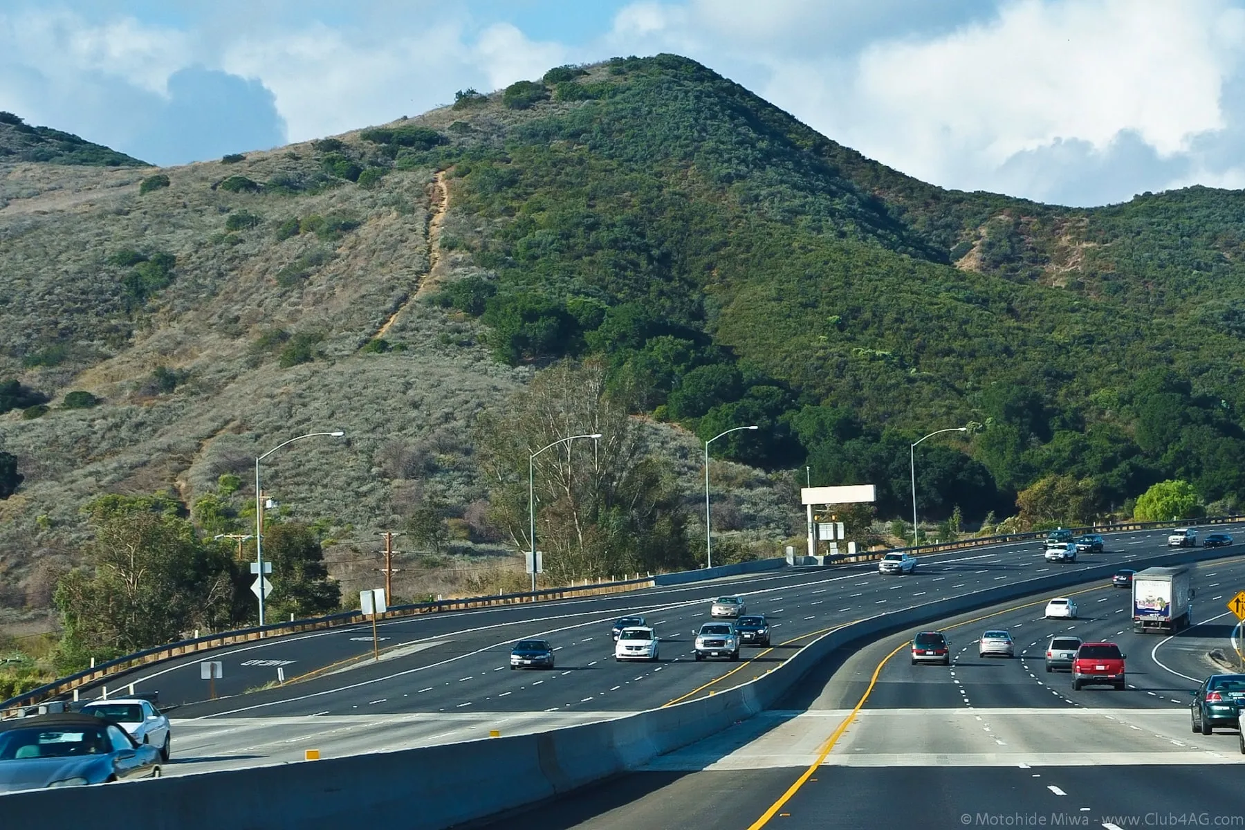 The 101 freeway winding past green hills in Calabasas