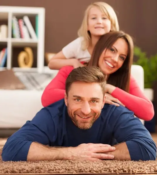 Family relaxing together on a soft, clean carpet